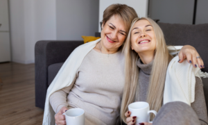 A middle-aged woman on a couch with her daughter